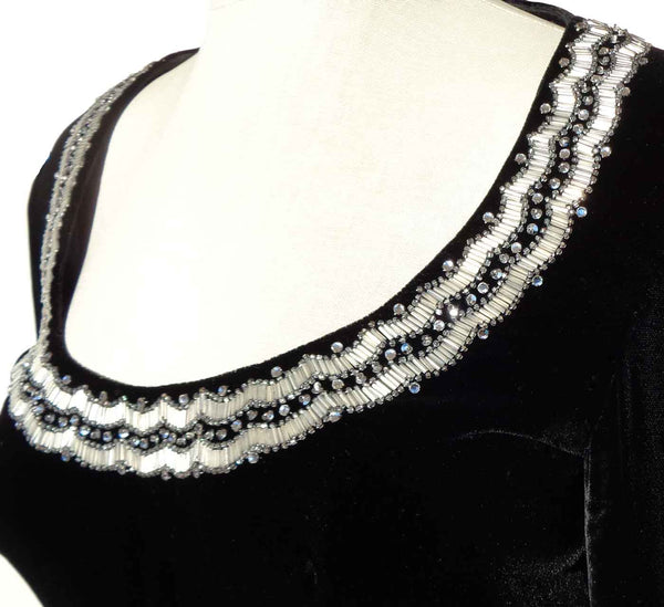 Black garment with white beaded neckline 